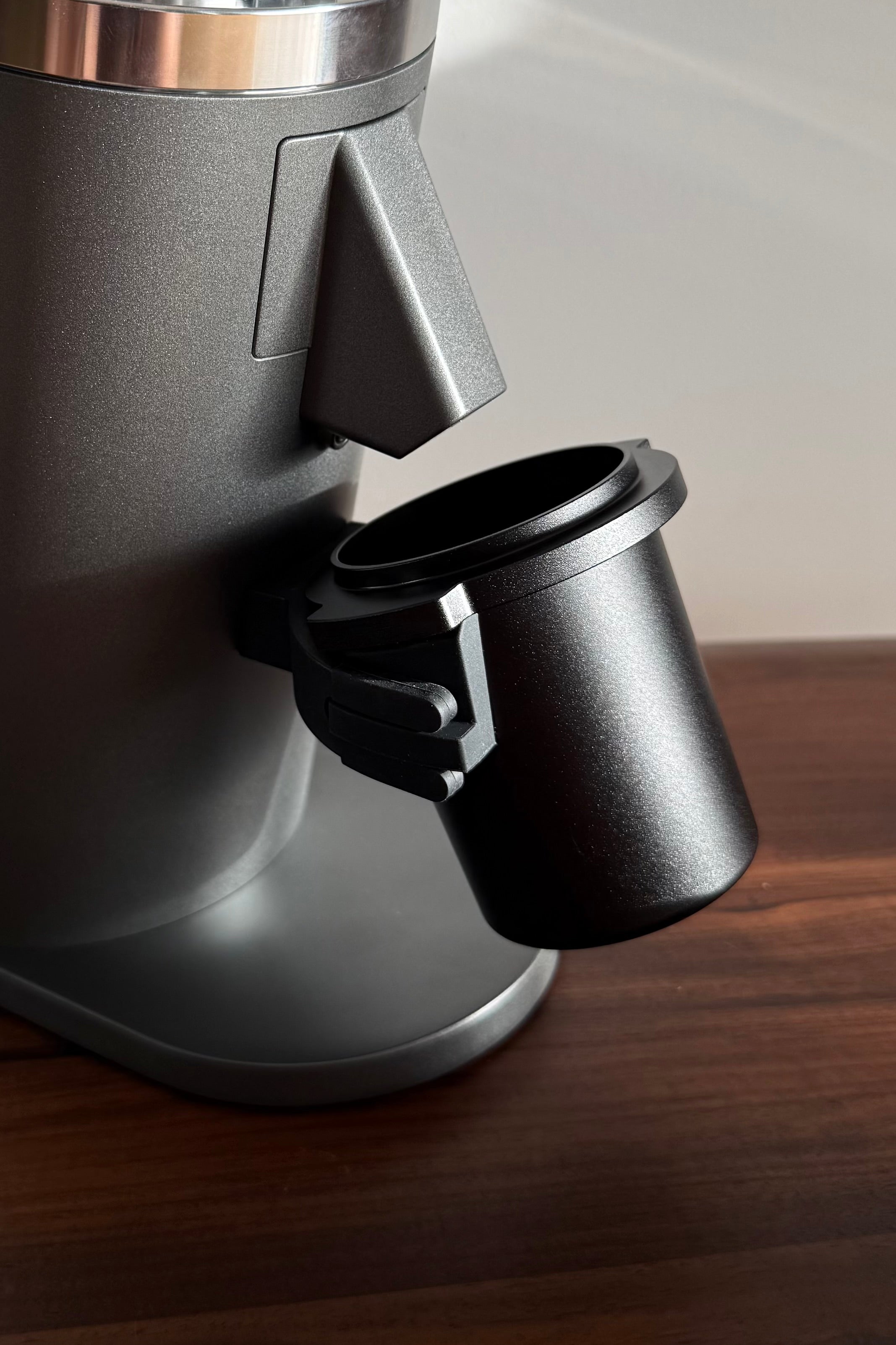 Metal dosing cup on a grey DF54 Coffee Grinder - Grind Logic