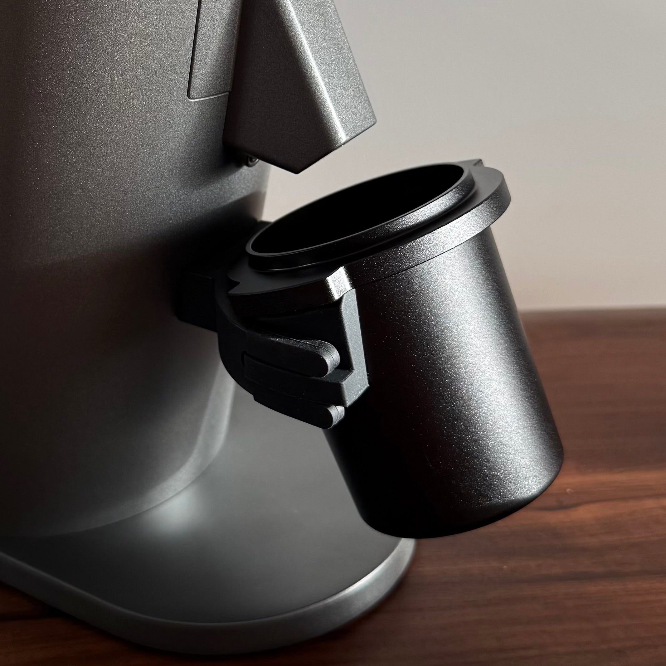 Metal dosing cup on a grey DF54 Coffee Grinder - Grind Logic