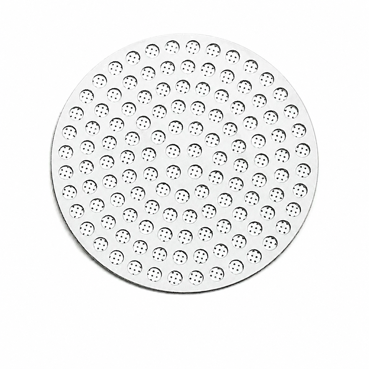 Top view of a perforated stainless steel espresso puck screen on a white background - Grind Logic