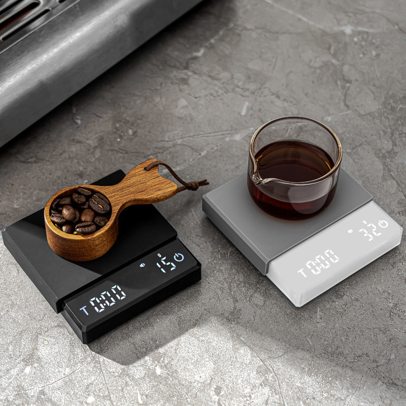 Grind Logic Mini Espresso Scale in black and white weighing coffee beans and brewed coffee