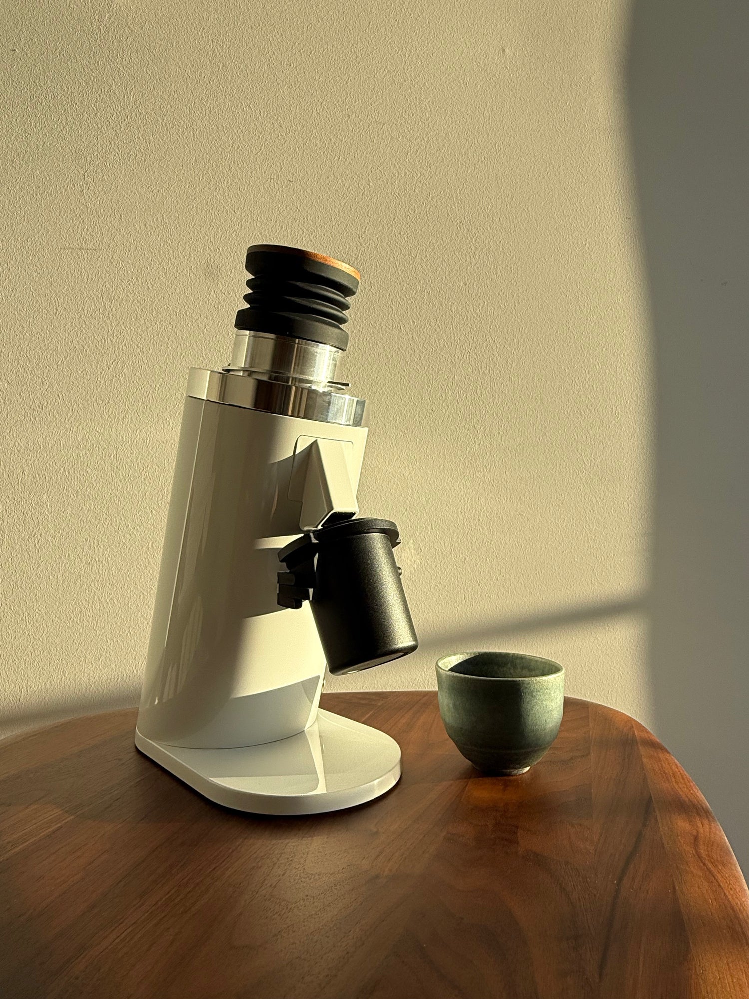 White DF64 Coffee Grinder on wooden table top with Celadon cup