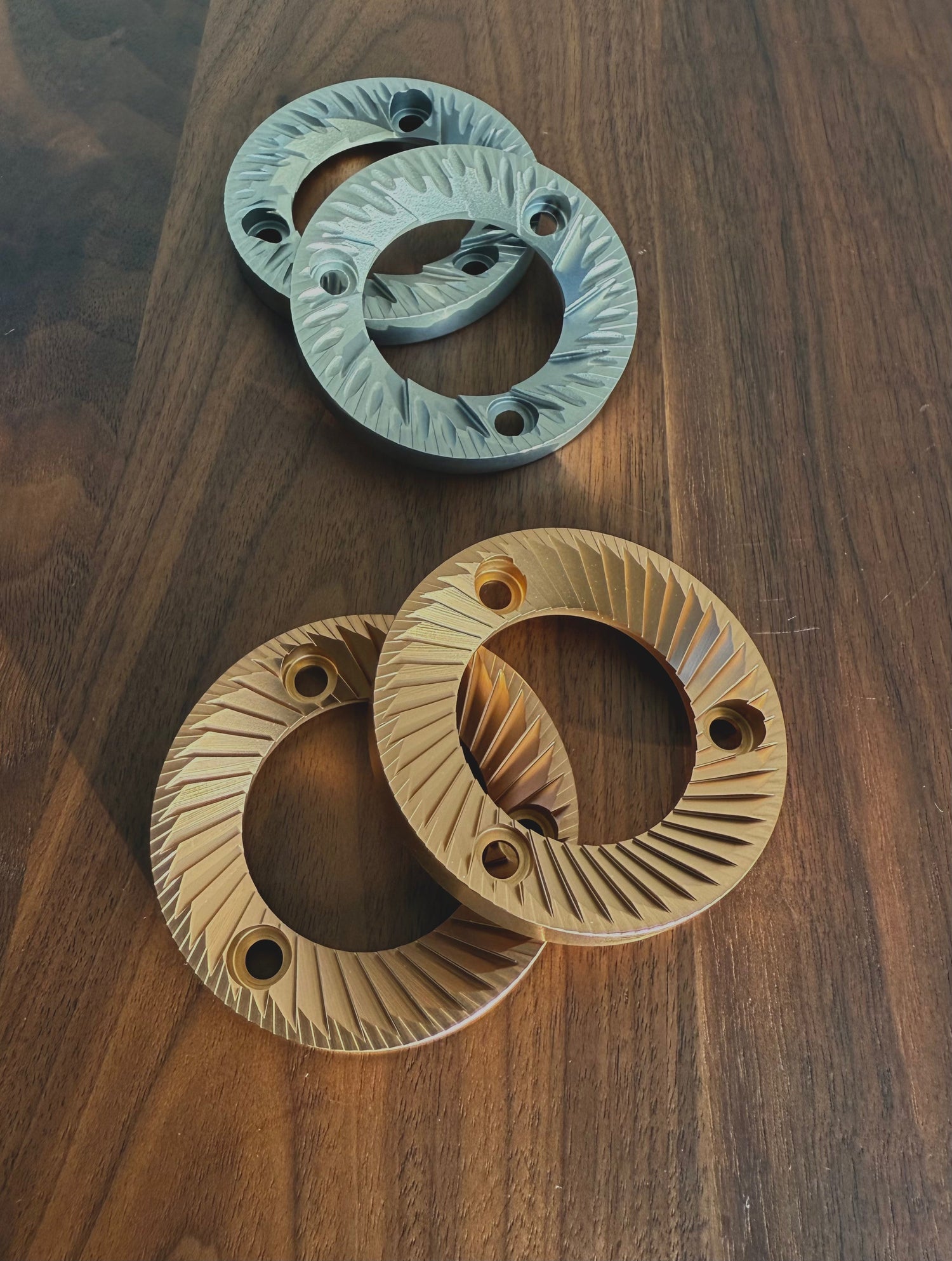64mm SSP Burrs (Lab Sweet silver knight and Multipurpose red speed coated)on wooden table top 