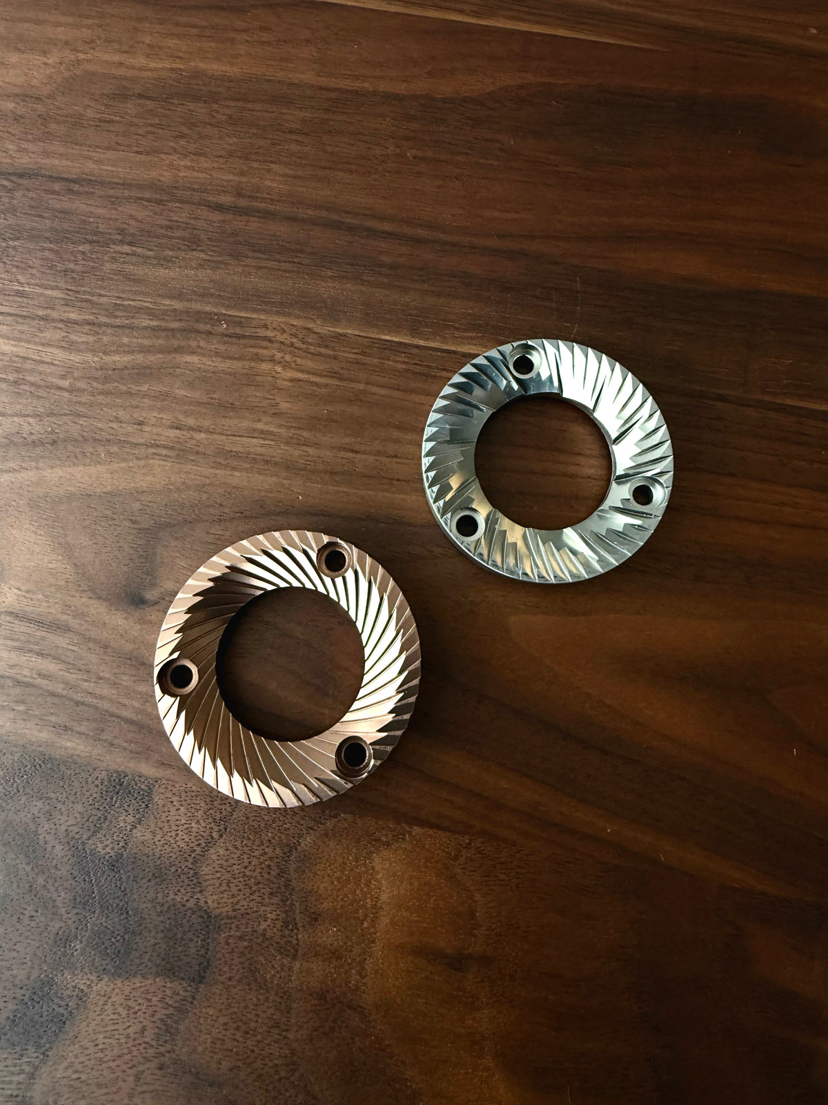 54mm Red Titanium coated Brew burr beside a 54mm uncoated stainless steel Espresso/Multipurpose burr for the DF54 coffee grinder - Grind Logic