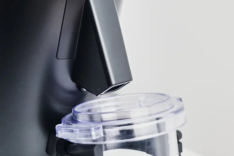 Black DF54 Coffee Grinder chute and dosing cup close up 