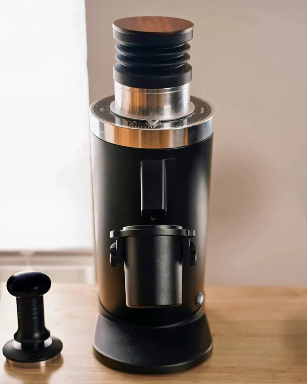 DF64 Gen 2 coffee grinder on a wooden surface with a neutral background