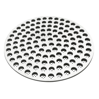 Perforated stainless steel espresso puck screen shown from an angled side view on a white background - Grind Logic