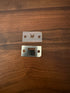 Metal and plastic pieces of the declumper for the DF54 Coffee Grinder on wooden surface 