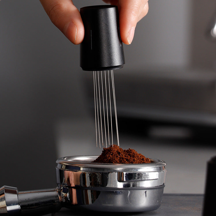 Black Grind Logic WDT tool using fine needles to distribute coffee grounds evenly in an espresso portafilter